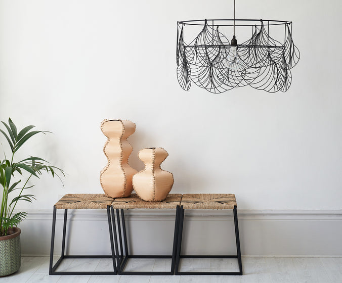 the alp collection 2020 showing the alp stool bench 105 with seagrass and leather rush weaving seat, the alp vessels 510 made with natural tan leather offcuts and the alp Ginkgo light made of recycled plastic, we are using local and sustainable materials