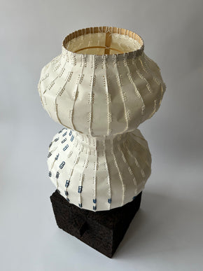 Chinese rice paper vessel with ribbed details on dark brown cork base