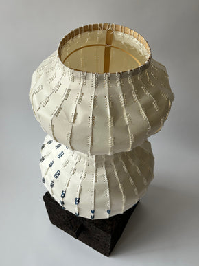 paper vessel over bamboo structure placed on cork base
